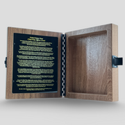 Wooden box with a black plaque inside on a light gray background